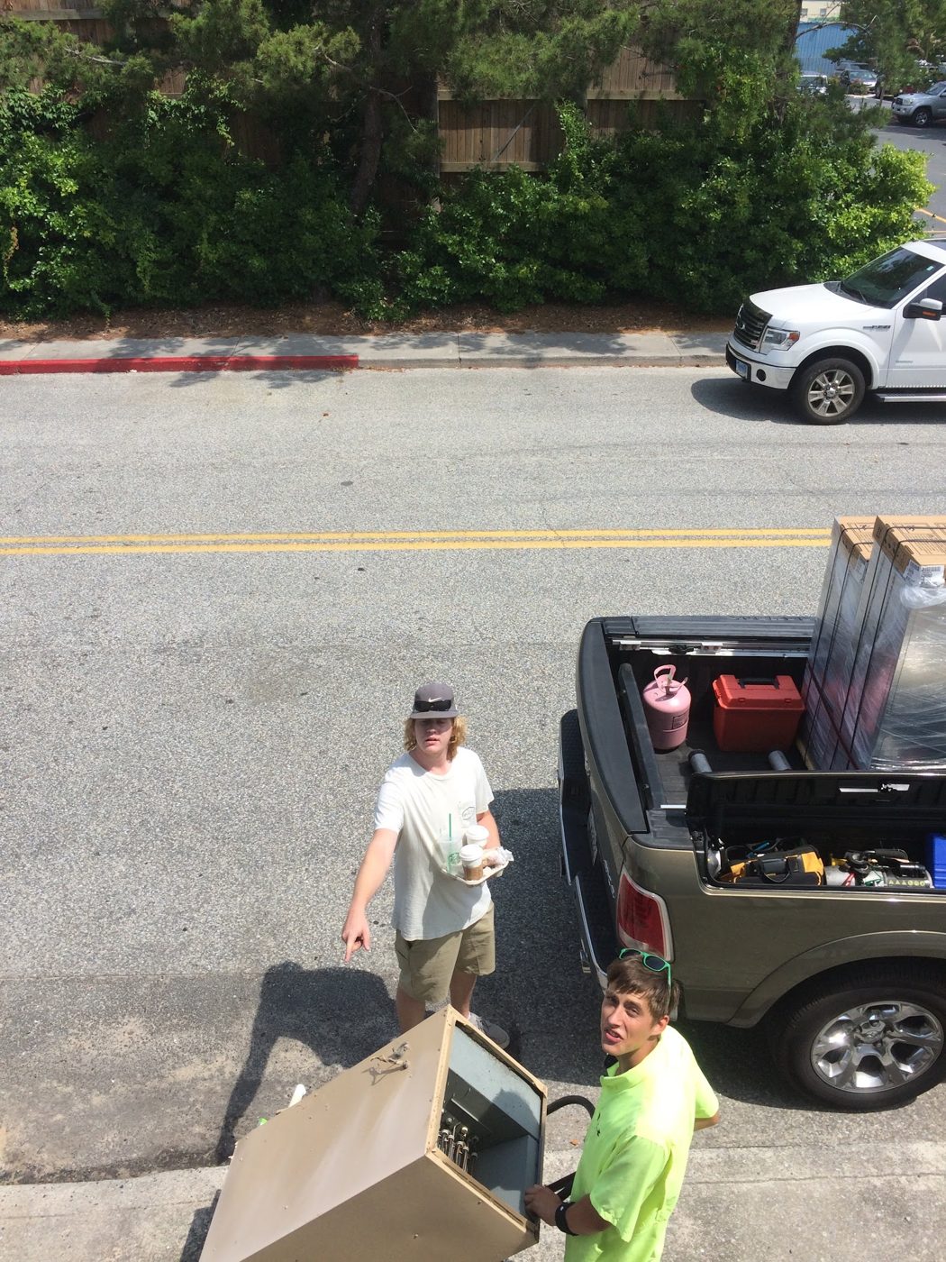 Crew unloading equipment from a pickup on a coastal street