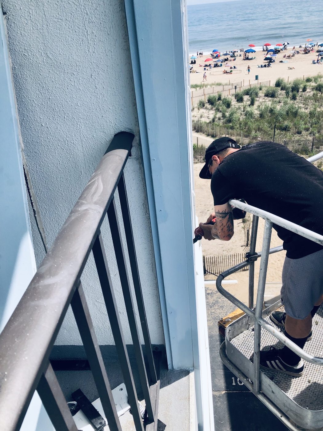 Technician working on an oceanfront balcony unit