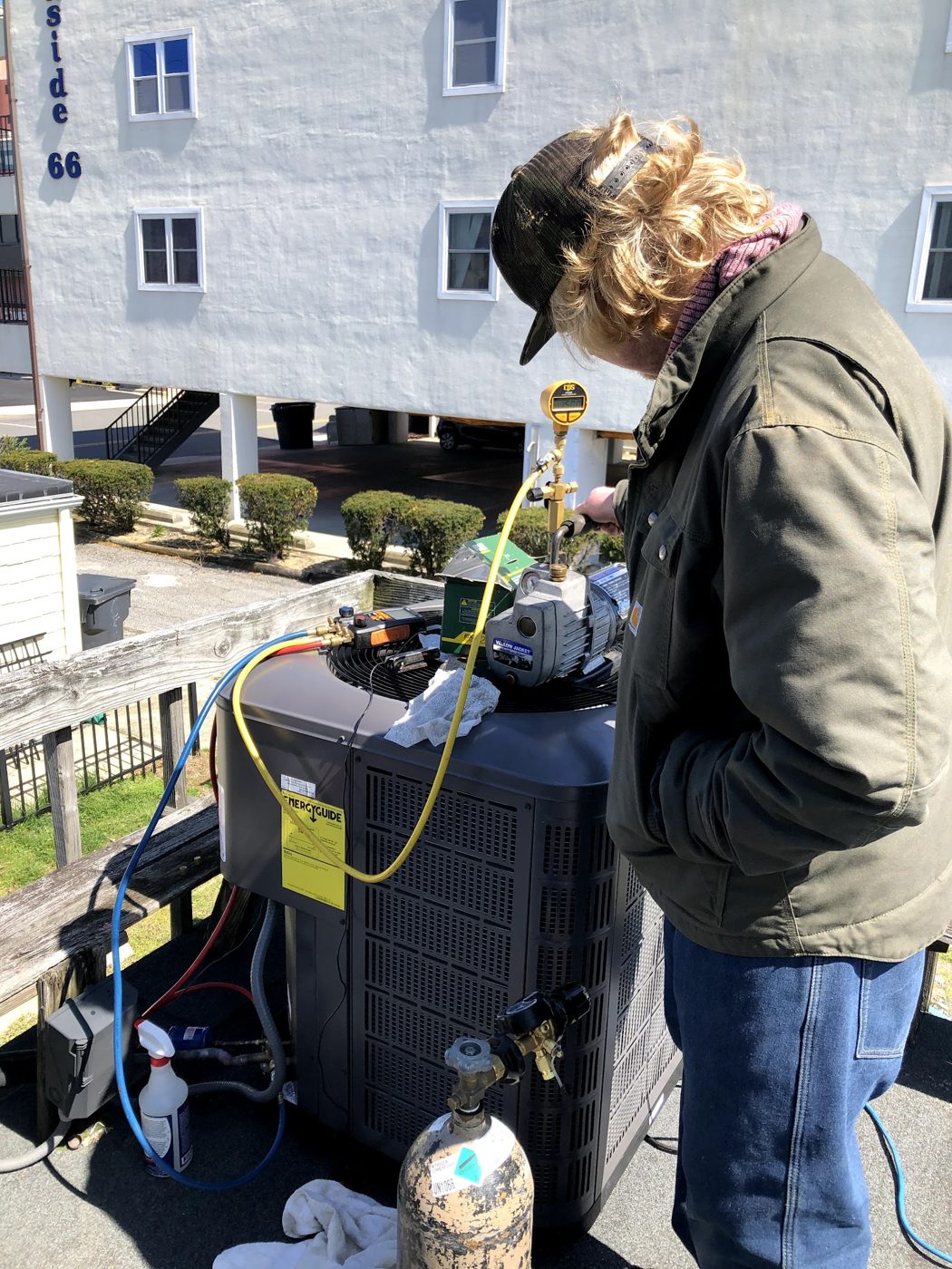 Jim Schiffler technician checking an outdoor system with service gauges
